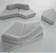 Gray cushioned sofa sectional on a white background